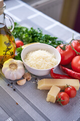 Grated parmesan cheese on a wooden cutting board at domestic kitchen