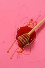 Honey dipper on pink background - Top view