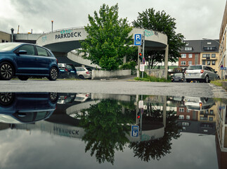 Driveway to Parking deck in europe with puddle reflection