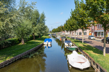 Small boats moored in a canal on the Zandslootkade in the South-Holland village of Sassenheim....