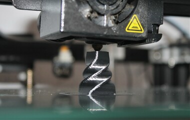 3d printing machine creating a twisted chess piece