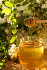 jar of honey with white flowers