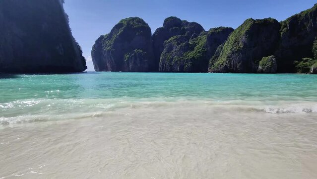 Natural background of beautiful tropical beaches. The coastline of Maya Bay, Phi Phi Ley Island, Thailand is amazing with white turquoise sea waves and foamy water surface.
