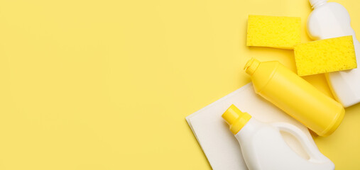 Set of cleaning supplies on yellow background with space for text