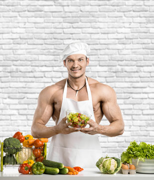 Man Bodybuilder In White Toque Blanche And Cook Protective Apron