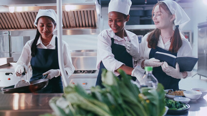 Group of schoolgirls having fun learning to cook. Female students in a cooking class.