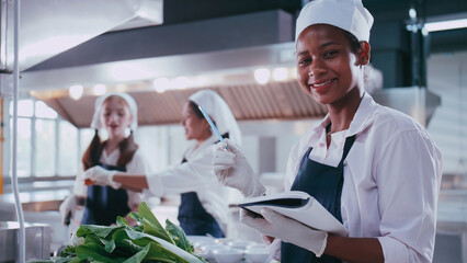 Group of schoolgirls having fun learning to cook. Female students in a cooking class.