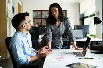 Colleagues arguing in office. Angry businesswoman yelling at her collegue