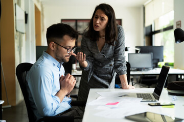 Colleagues arguing in office. Angry businesswoman yelling at her collegue