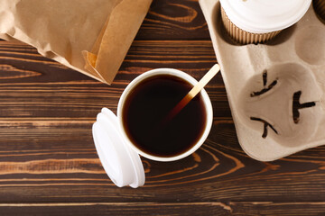Takeaway paper cups of coffee on wooden background