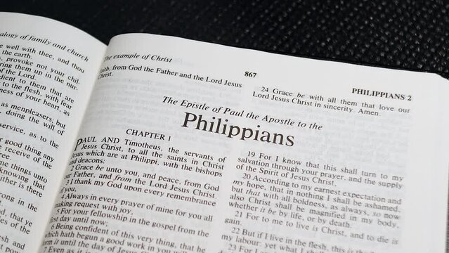 Close Up Shot of  Bible Page Turning to the book of Philippians