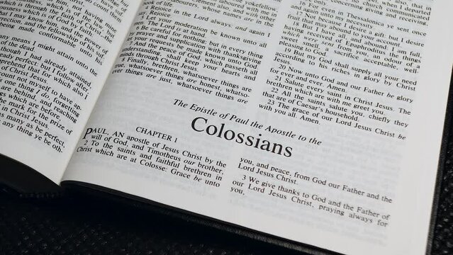 Close Up Shot of  Bible Page Turning to the book of Colossians