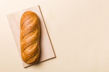 freshly baked bread with napkin on rustic table top view. Healthy white bread loaf isolated