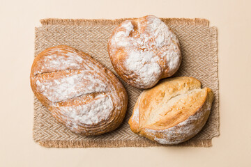 Assortment of freshly baked bread with napkin on rustic table top view. Healthy unleavened bread. French bread