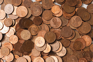 Large pile of shiny copper euro coins of small value.