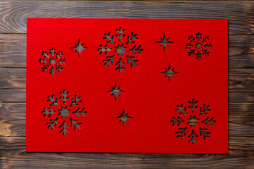 Top view of red tablecloth for food on wooden background. Empty space for your design