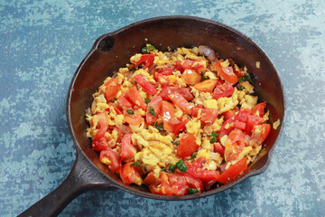 ready to fry chopped onions, tomatoes chilies, egg and barbequed brinjal