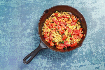 ready to fry chopped onions, tomatoes chilies, egg and barbequed brinjal
