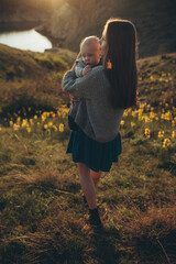 Woman and baby in nature. Mom and baby are relaxing in the park. High quality photo