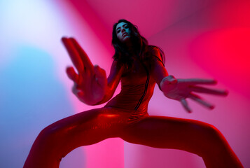 Female dancer posing with red and blue lighting