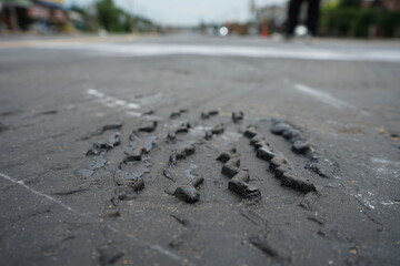 Car tire tracks on paved road