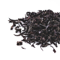 dried black tea on a white acrylic background