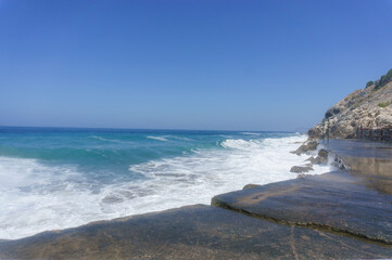 waves crashing against the surf