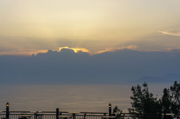 cafe with lanterns against the background of the sea and sunset