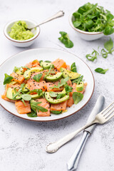 Salmon salad with avocado,  for keto and low carb diet. Rusty background, top view, copy space.