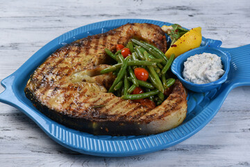 large beluga steak with vegetables and sauce