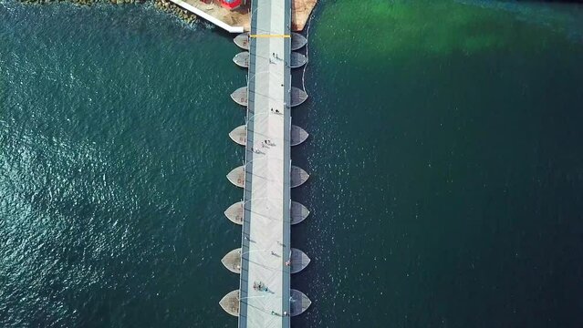 Tilt up aerial view of the Queen Emma Bridge in St. Anne's Bay towards the Otrobanda district in the city of Willemstad, capital of Curacao, Dutch Caribbean island.