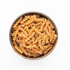 Whole fusilli pasta in a wooden bowl.