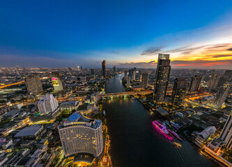 Fototapeta na wymiar Aerial view of Saphan Taksin district near the Taksin bridge and Chao Phraya river, Bangkok, Thailand