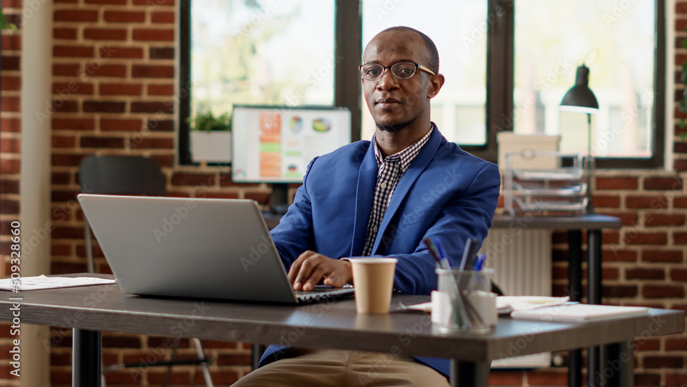 Poster portrait of executive assistant using online website on laptop for startup project. male employee pl