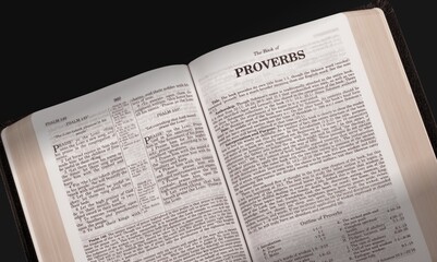 Open Bible with letters for the words of Jesus Christ, opened to the book on desk.