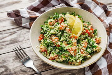 arabic salad tabbouleh on a rustic wooden background
