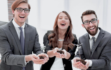 three colleagues look at the young shoots