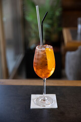 Glass of aperol spritz cocktail served on a table