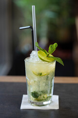 Mojito cocktail served in a glass with straws