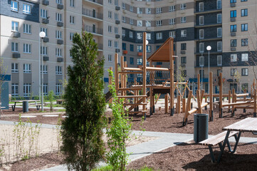 Fototapeta na wymiar Playground at summer time in a city yard