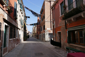 Fototapeta na wymiar Strange street of Venice with a Gondola