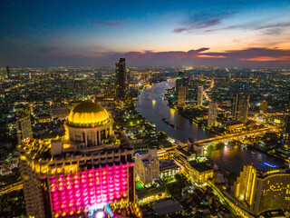 Obraz premium Aerial view of Saphan Taksin district near the Taksin bridge and Chao Phraya river, Bangkok, Thailand