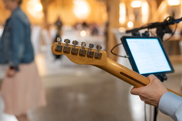 Top part of a wooden guitar being played