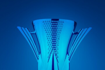 Shiny winning trophy against blue background