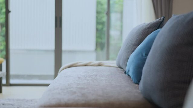 Close-up of beige earth tone pillow cushion set arrange on sofa couch in living room interior design home sweet home ideas concept,set of colour pillow arrange on sofa in living room home concept