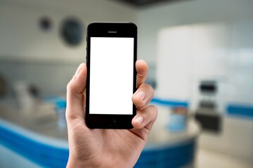 Smart home concept.  Woman holding mobile phone on home interior background. Internet of things, comfort in house