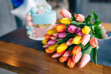 beautiful bright tulips and a delicious cake in honor of the holiday