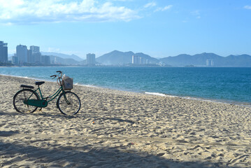 Fototapeta premium Lonely bicycle parked on sandy beach