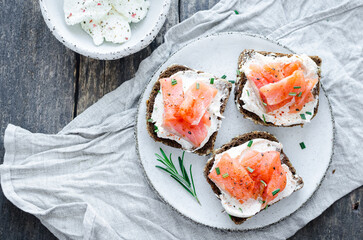 Healthy breakfast - toast with rye bread, salmon and cream cheese