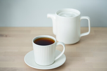 Tea time. Cup of tea with a teapot.